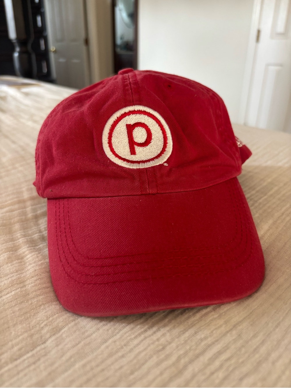 Pure Barre Alternative Red Baseball Cap with Cream Embroidered Circle Logo